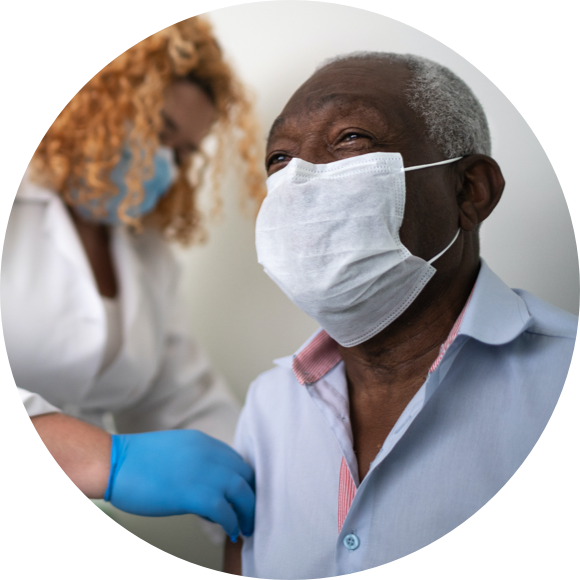 Image of a man wearing a mask and getting a vaccine