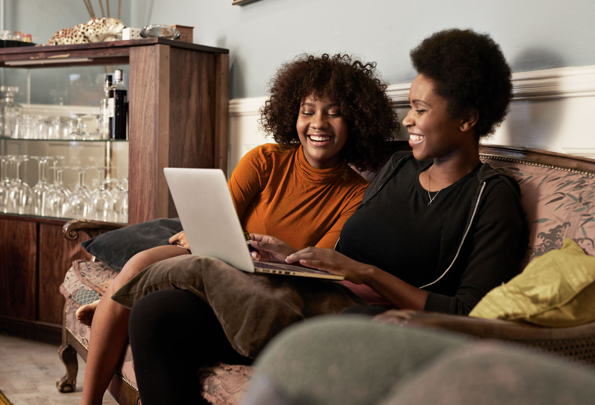Two women looking at a laptop computer