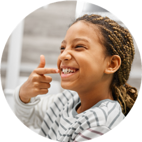 girl pointing at her teeth